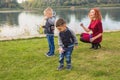 Family and nature concept - Mother and their children playing with colorful soap bubbles Royalty Free Stock Photo