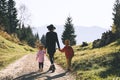 Family in nature outdoor. Woman with kids on hiking trail in mountains Royalty Free Stock Photo