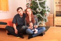 Family with newborn baby boy by Christmas tree Royalty Free Stock Photo