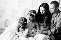 family and a newborn baby in the hands of his older sisters. black and white photo Royalty Free Stock Photo