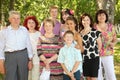 Family of nine people pose at park