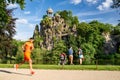 A family with one child and on runner in Buttes Chaumont Park, Paris Royalty Free Stock Photo