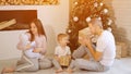 Family opening Christmas gifts near tree Royalty Free Stock Photo