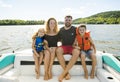 Family out boating together having fun on vacancy