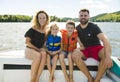 Family out boating together having fun on vacancy