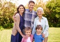 Family, outdoor and portrait for holiday, vacation and backyard with children and smile with love. Mom, dad and grandma Royalty Free Stock Photo