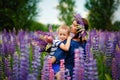 Family outdoor recreation on weekends. A happy mother and a cute baby son are hugging tightly among wild flowers in a field. Royalty Free Stock Photo