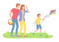 Family outdoor recreational activities, parents looking at son with flying kite, recreation time Royalty Free Stock Photo