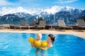 Family in outdoor swimming pool of alpine spa resort Royalty Free Stock Photo