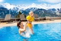 Family in outdoor swimming pool of alpine spa resort Royalty Free Stock Photo