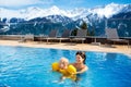 Family in outdoor swimming pool of alpine spa resort Royalty Free Stock Photo