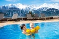 Family in outdoor swimming pool of alpine spa resort Royalty Free Stock Photo