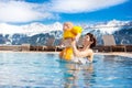 Family in outdoor swimming pool of alpine spa resort Royalty Free Stock Photo
