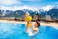Family in outdoor swimming pool of alpine spa resort Royalty Free Stock Photo