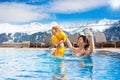 Family in outdoor swimming pool of alpine spa resort Royalty Free Stock Photo