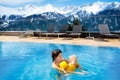 Family in outdoor swimming pool of alpine spa resort Royalty Free Stock Photo