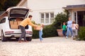 Family Outside New Home On Moving Day Loading Or Unloading Boxes From Car Royalty Free Stock Photo