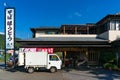 Family owned vegetable shop with delivery lorry, track on foreground