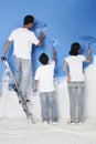 Family painting wall together. Conceptual image Royalty Free Stock Photo