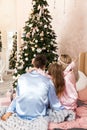 Happy family mother father and child on Christmas morning in bed in pajamas Royalty Free Stock Photo