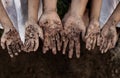 Family parent and children showing dirty hands after planting the tree together Royalty Free Stock Photo