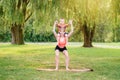 Family parental activity. Young Caucasian mother with child toddler boy doing workout yoga fitness outdoor in park on summer day. Royalty Free Stock Photo