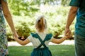 Family, parenthood, adoption and people concept. happy mother, father and little girl walking in summer park