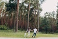 Family, parenthood, adoption and people concept - happy mother, father and little girl walking in summer park and have fun. Royalty Free Stock Photo