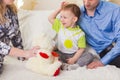 Family, parenthood and children concept - Close-up of happy mother, father and son playing together with teddy bear on Royalty Free Stock Photo