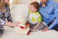 Family, parenthood and children concept - Close-up of happy mother, father and son playing together with teddy bear on Royalty Free Stock Photo