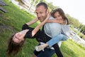 Family parenthood fatherhood concept happy man father and two little girl daughter in piggyback having fun in summer