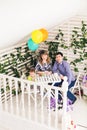 Family, parenthood, happy birthday and holiday concept - happy parents and child at a table drinking tea and eating cake Royalty Free Stock Photo