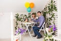 Family, parenthood, happy birthday and holiday concept - happy parents and child at a table drinking tea and eating cake Royalty Free Stock Photo