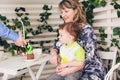 Family, parenthood, happy birthday and holiday concept - happy parents and child at a table drinking tea and eating cake Royalty Free Stock Photo