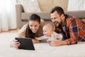 Mother, father and baby with tablet pc at home Royalty Free Stock Photo