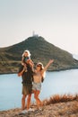 Family parents with child travel outdoor mother and father with daughter enjoying landscape active vacations