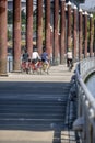 Family of parents with children traveling on bicycles on the floating dock on the Willamette River preferring active healthy