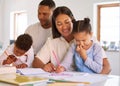 Family, parents help their children with homework and books on desk at their home. Support with writing or reading Royalty Free Stock Photo