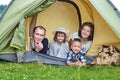 Family Parents and two children in camp tent. Happy Mother, father, son and daughter on Summer vacation Royalty Free Stock Photo