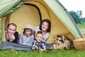 Family Parents and two children in camp tent. Happy Mother, father, son and daughter on Summer vacation Royalty Free Stock Photo