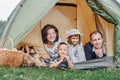 Family Parents and two children in camp tent. Happy Mother, father, son and daughter on Summer vacation Royalty Free Stock Photo