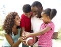 Family In Park With American Football Royalty Free Stock Photo