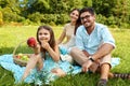 Family In Park. Happy Young Parents And Child Relaxing Outdoors Royalty Free Stock Photo