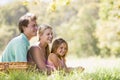 Family at park having a picnic and smiling Royalty Free Stock Photo