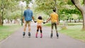 Family, park and holding hands to rollerskate with girl child with care, learning and support. Interracial parents