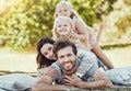 Family, park and portrait of parents, children and happy people on garden grass in sunshine. Kids, mom and dad smile