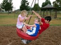 Family on Park Swing Playing