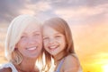 Happy mother and daughter portrait over summer sky Royalty Free Stock Photo