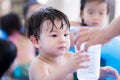 Family people hands handed a plastic cup to the boy who was wet. Cute kid is thirsty. Royalty Free Stock Photo