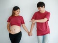 Family, people lifestyle concept. A beautiful young Asian pregnant lady smiling standing with a happy man against white background Royalty Free Stock Photo